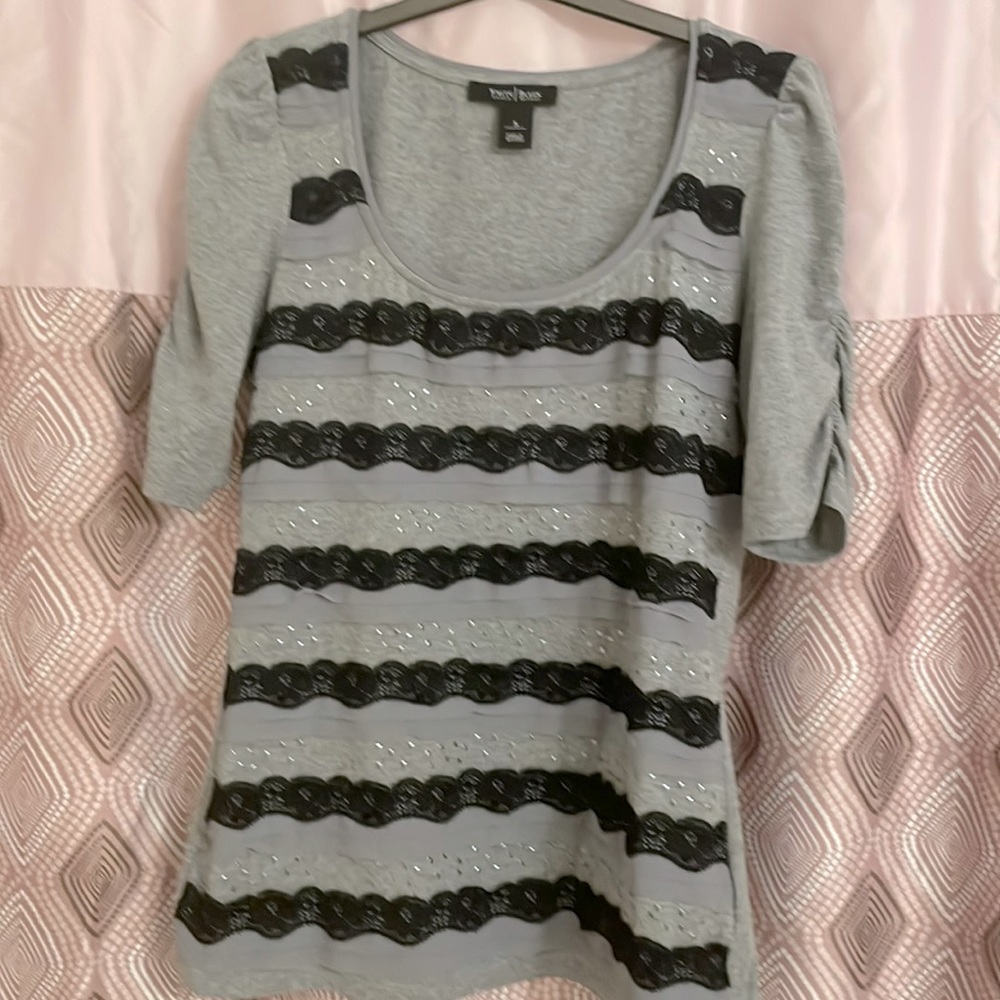 Light gray top with black lace and silver accents.